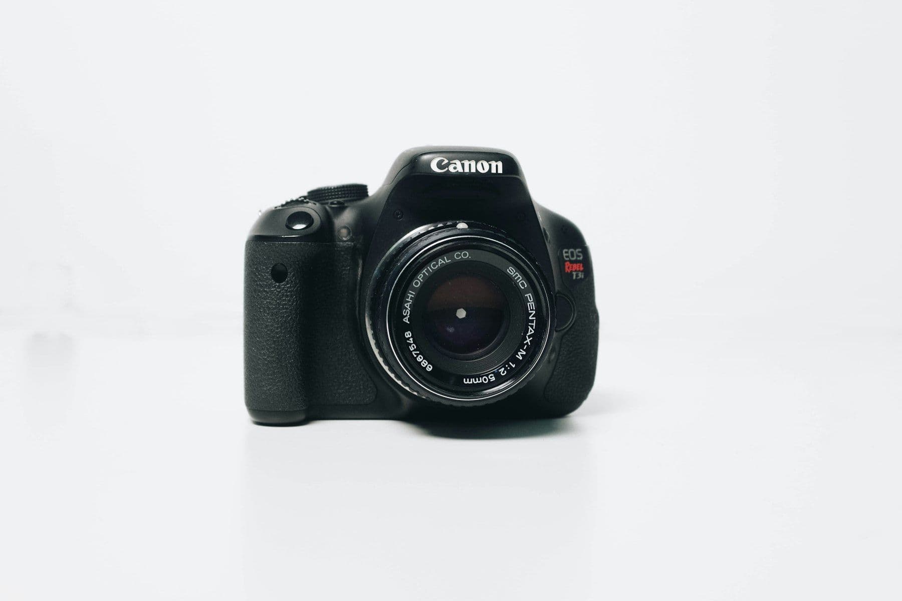 Black camera on a white surface