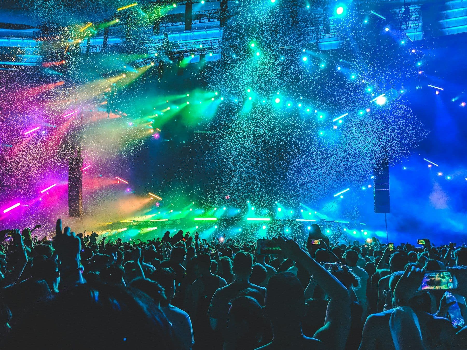Crowd at a concert under coloured stage lights