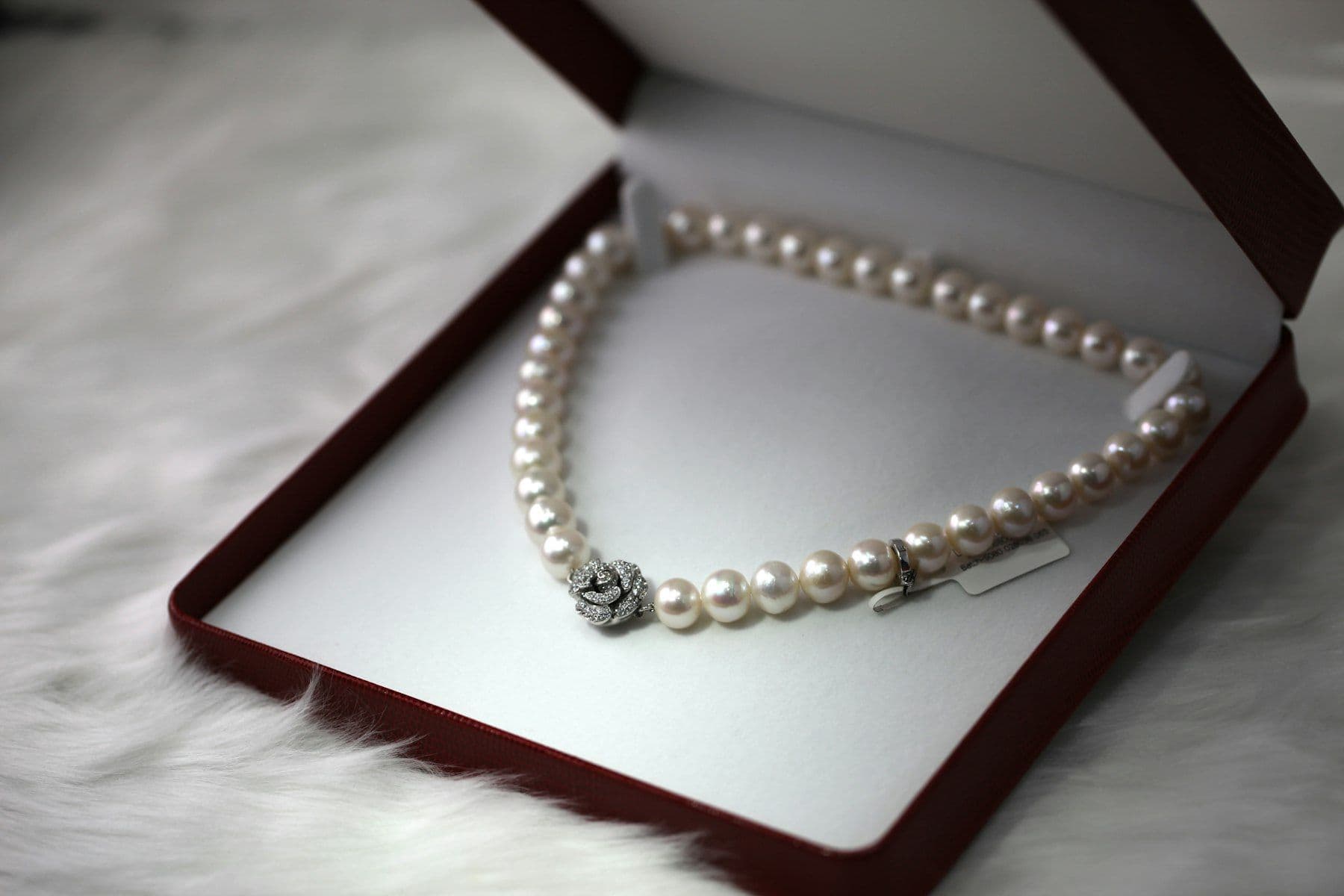 Pearl necklace resting in an open jewellery box