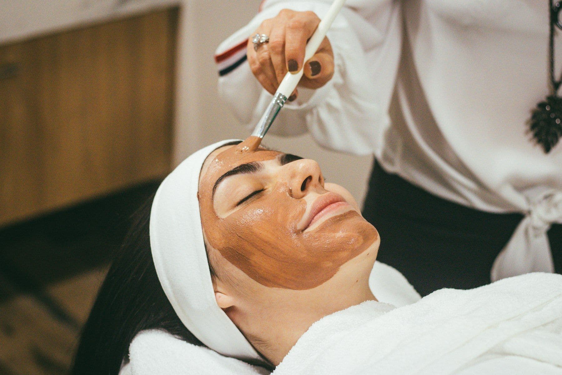 Facial mask being applied with a brush