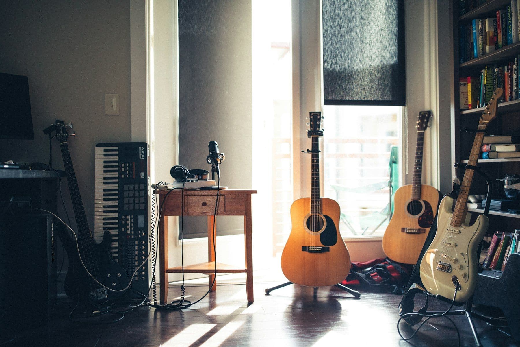 Guitars and a keyboard in a sunlit room