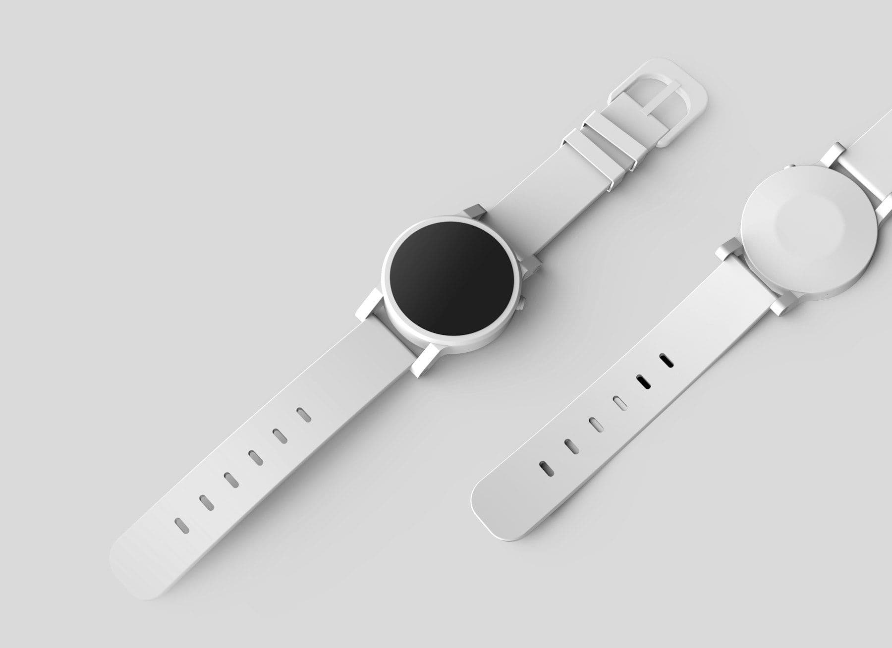 Two minimal white watches on a grey surface