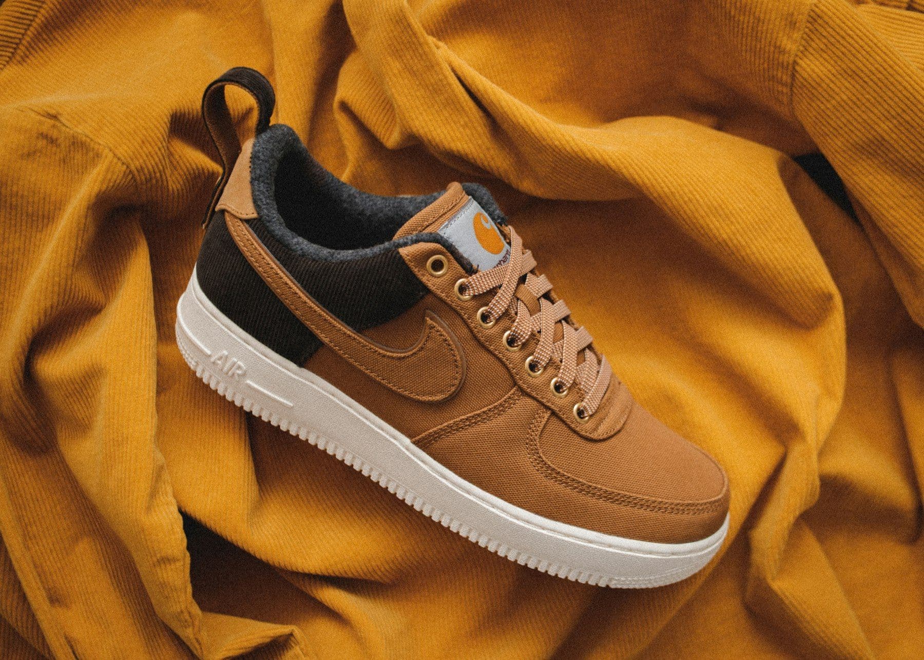 Tan leather sneaker on mustard fabric